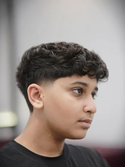 This young client looks sharp with his new textured crop and taper fade.