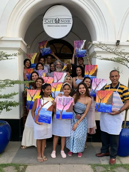 The finished products from our Kochi workshop, proudly displayed by the artists. It was a beautiful day of painting against the stunning backdrop of Cafe Noir.