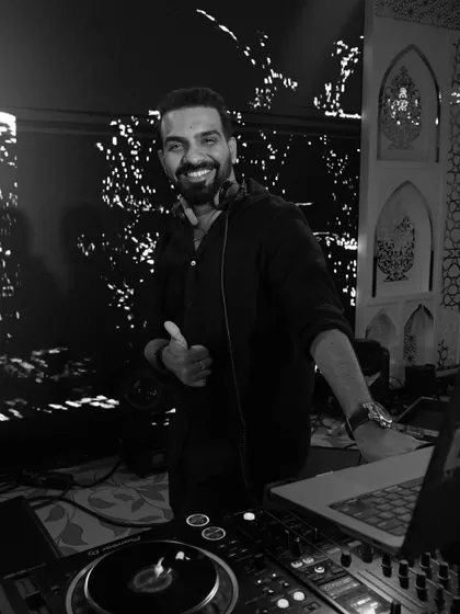 Happiness is just a beat away. A black and white shot of me giving a thumbs-up from the DJ booth.
