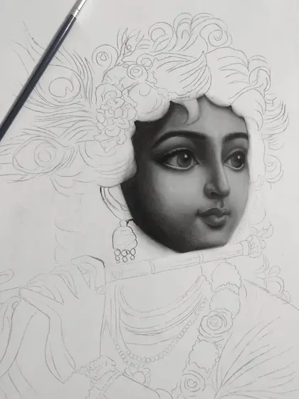 The first work-in-progress stage of my Krishna charcoal drawing. Here, the face is almost fully rendered, contrasting with the empty outline of the rest of the figure.