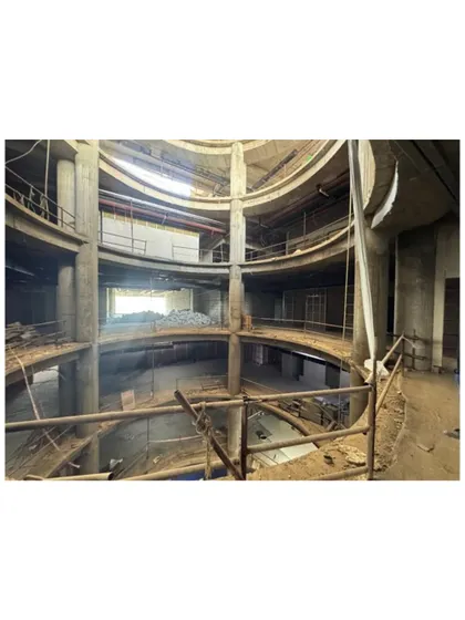 This construction photo shows the scale of the atrium at Sant Nirankari Hospital. The space is designed to anchor the hospital's spatial organization, seamlessly integrating movement, light, and visibility.