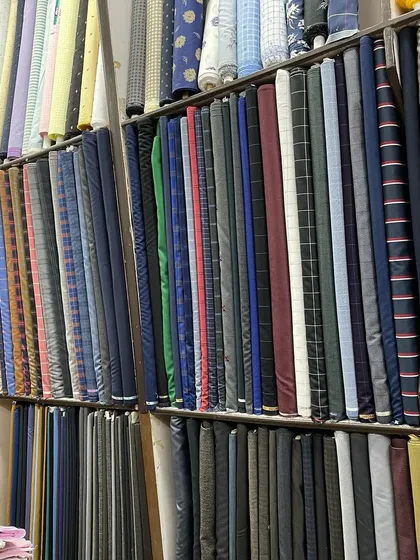 More of my extensive suiting fabric collection, featuring classic checks, pinstripes, and solid colors for formal wear.
