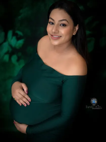 I love playing with different moods in my studio. For this portrait, we chose a deep emerald green off the shoulder dress and a dark, leafy backdrop to create a rich, artistic image that feels both intimate and dramatic.