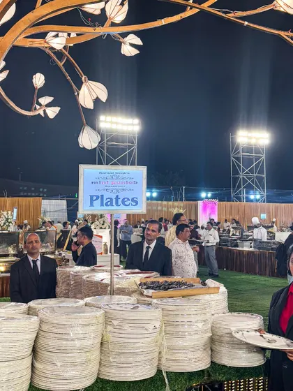 In large-scale catering, organization is key. This is a look at one of my plate stations, neatly arranged and staffed to handle a high volume of guests efficiently during a busy event.