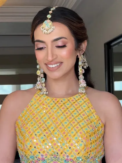 A close-up of the soft, natural glow and pink liner for this Haldi look. The pink eyeshadow is blended beautifully for a subtle wash of color.