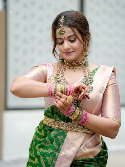 A graceful pose showing the intricate bangles and the statement ring that are part of the set.
