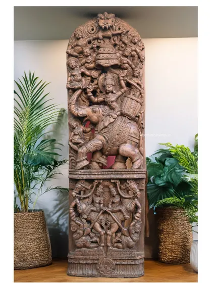 The Raj Bhavani panel shown in a different interior setting, surrounded by plants that complement its natural wood material.