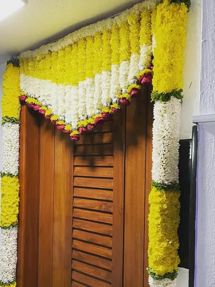 This is a closer look at the intricate floral toran I created for a doorway. The pattern of yellow and white flowers is a classic design for welcoming guests during festive occasions.