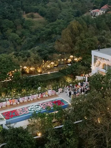 An aerial view of the picturesque glass house and poolside setting for the Lagan Lakhwanu ceremony. The space was designed to create vibes both warm and emotional for the new beginning.