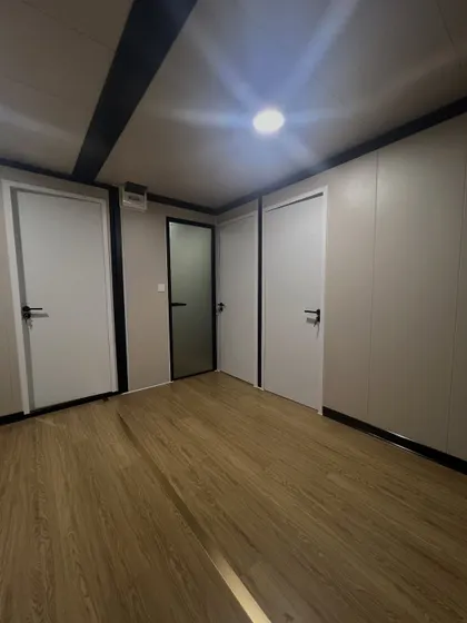 This image shows a hallway in a modular home with clean lines and a simple color palette. The design emphasizes a sense of space and flow between different rooms.