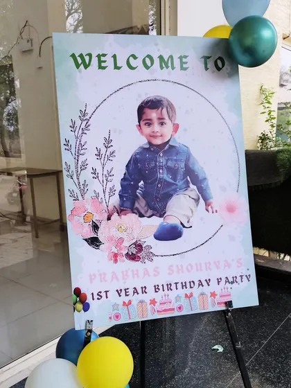Another example of a custom welcome sign with a photo for a first birthday.