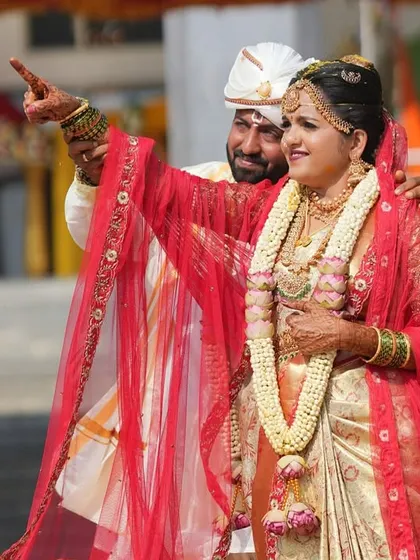 A candid shot of the bride and groom, full of joy. The makeup is designed to be sweat-proof and long-lasting, ensuring the bride looks fresh throughout the day's events.