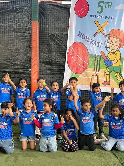 The whole cricket crew! A group of excited kids in their custom blue jerseys, ready to celebrate after a fantastic game.