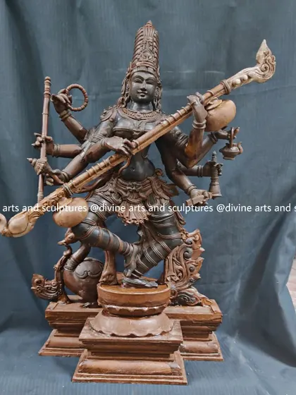 The wax model of Goddess Saraswati, the patron of knowledge, music, and the arts. She is shown in a dynamic pose, playing the veena, with her swan vahana (vehicle) at her feet.