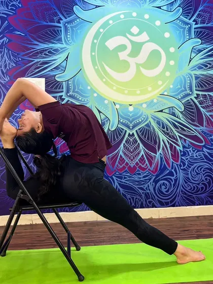 A breathtaking backbend using a chair for support, demonstrating the advanced flexibility our students can achieve.