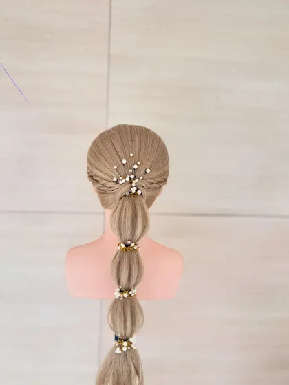 A full view of the finished bubble braid, showing its clean sections and elegant pearl embellishments.