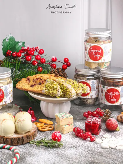 A Christmas treat collection featuring biscotti, fudge, and cookies in jars, creating a perfect holiday gift idea.
