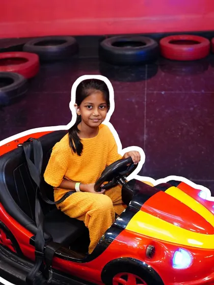 A young driver enjoying the bumper cars. We ensure all our rides and games are well-maintained and supervised for a safe experience.