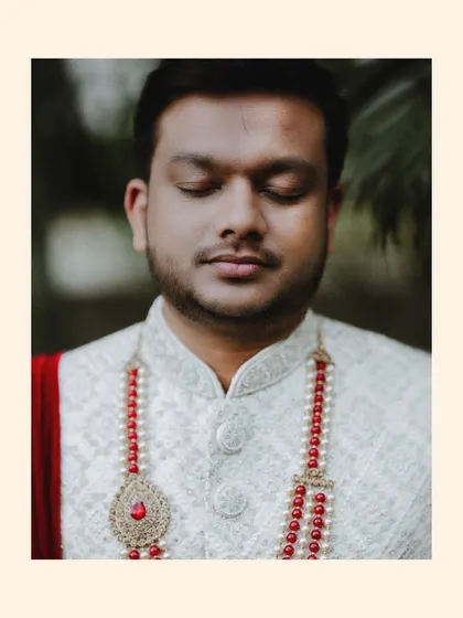A duplicate of the groom's serene, eyes-closed portrait.