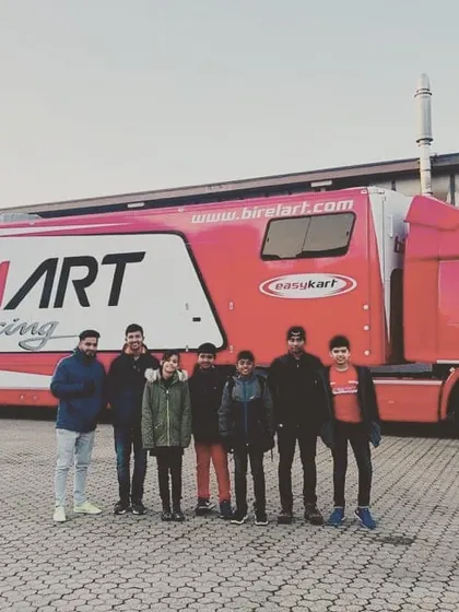 Another shot of our drivers with the Birel ART Racing truck, a symbol of our professional and well-equipped operation.