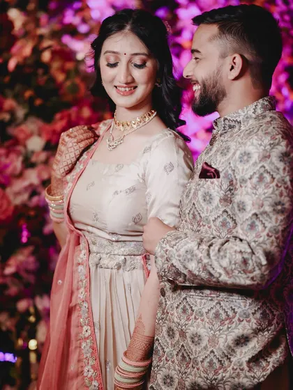 Another beautiful, candid moment of the couple enjoying their engagement celebration, with colorful lighting adding to the festive mood.