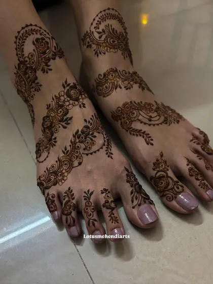 An eye-catching and intricate floral vine design for the feet, inspired by a picture the client loved.