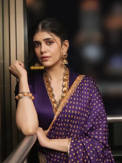 Sanjana Sanghi in an urban setting, proving that traditional jewelry can be styled in a contemporary and chic way.
