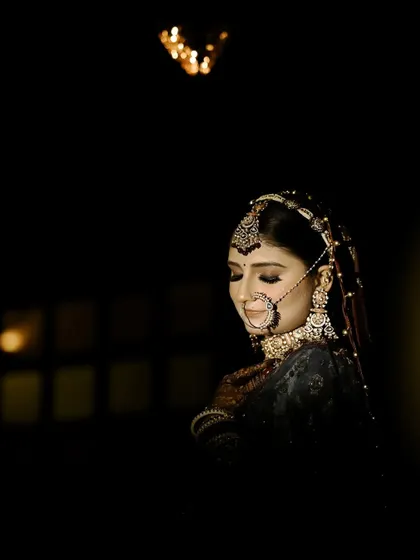 I love using shadows and light to create drama. This bridal portrait focuses on the bride's calm expression and the intricate details of her nath and jewellery, creating a timeless, cinematic feel before the main ceremony.