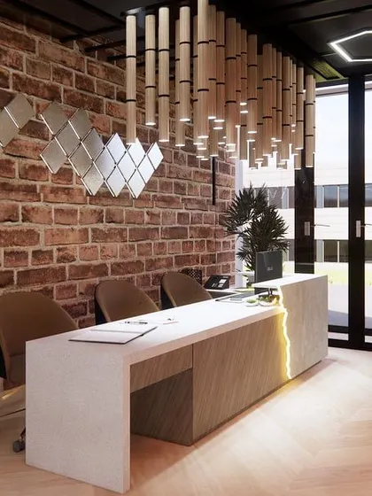 The reception desk at the gym, with its custom lighting and broken-brick wall effect, creates a raw yet polished look. This space sets the tone for a high-energy workout environment.