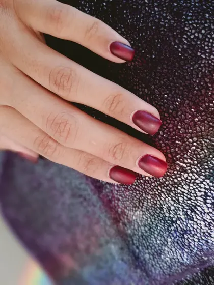 A sophisticated matte red polish, perfect for a chic and confident look.
