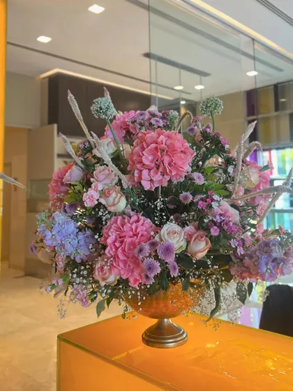 We transformed a restaurant space with beautiful pink floral arrangements, including a stunning cherry blossom tree centerpiece and lush table runners, creating a soft and romantic dining experience.