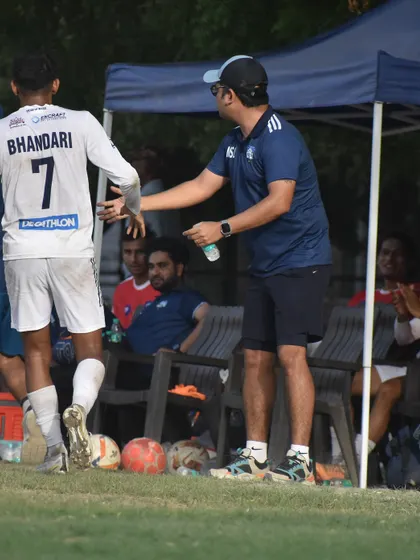 A moment of guidance from the sidelines. Our coaches are actively involved in every second of the game, providing real-time feedback to players.