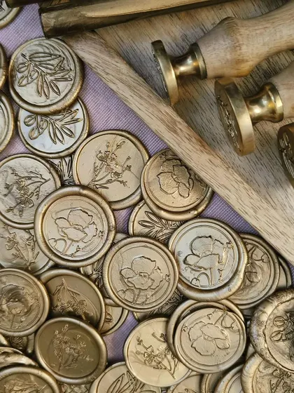 A duplicate image of our collection of gold wax seals and brass stamps.