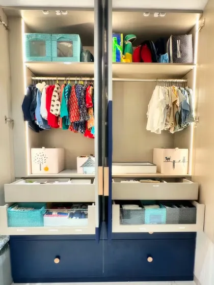A look at a beautifully organized kid's wardrobe. We use bins, kid-friendly hangers, and accessible drawers to create a system that children can learn to maintain themselves.