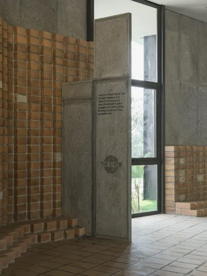 The entrance to 'The Earth' showcases our use of locally sourced CSEB walls flowing seamlessly into granite inlay flooring. This detail highlights our focus on craftsmanship and sustainable, locally-sourced materials.
