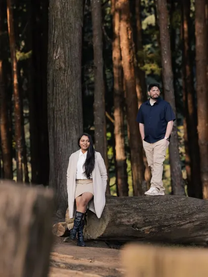A relaxed pose against a fallen tree in a beautiful forest setting. This image from their pre-wedding session feels natural, comfortable, and effortlessly cool.