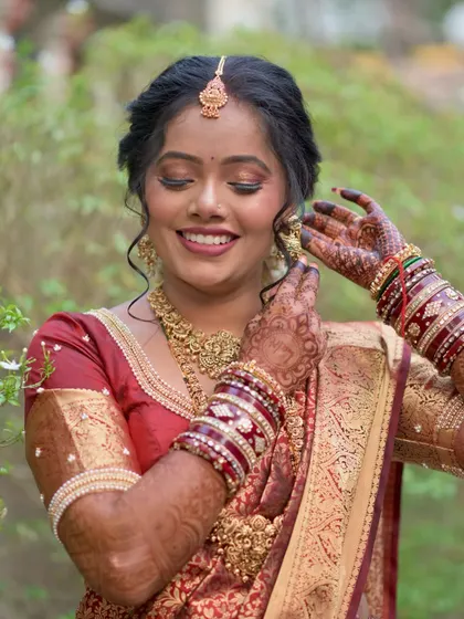 A radiant, smiling portrait. The bride looks absolutely stunning and ready for her big day in this classic South Indian look.