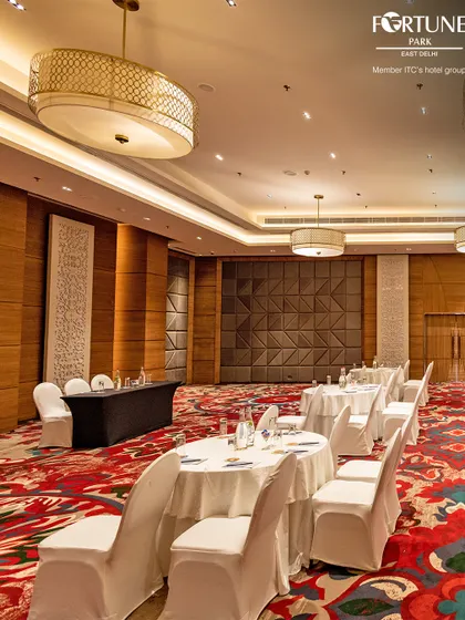 This view showcases the scale of my banquet hall, set up for a corporate event. The combination of elegant decor and practical arrangement makes it a prime venue for conferences and company-wide meetings in East Delhi.