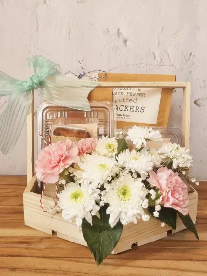 A thoughtful gift for Mother's Day, this wooden crate hamper combines fresh flowers with our delicious baked goods, creating a perfect token of love and appreciation.
