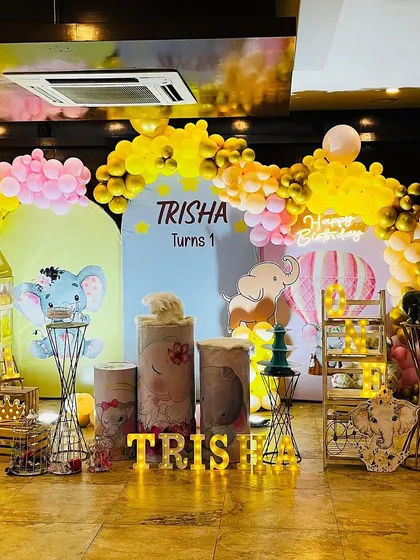 A colorful baby elephant theme with hot air balloon accents, perfect for a first birthday.