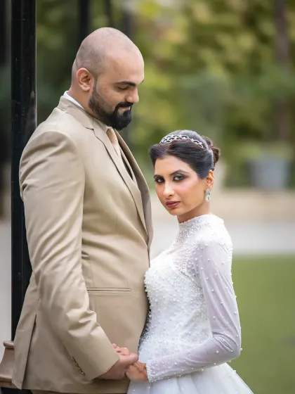 A powerful and stylish wedding portrait. The bride's direct gaze at the camera adds a touch of confidence and modern elegance to this couple's photo.