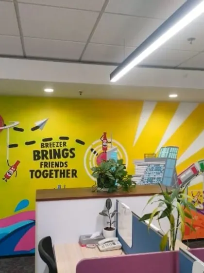 A wide view of the dynamic graffiti mural we created for the Breezer office near MG Road. The artwork spans the length of the wall, filling the workspace with color and energy.