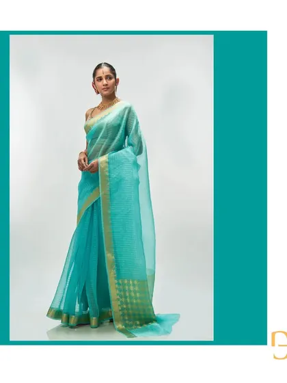 A side view of the aquamarine saree, highlighting its airy quality and the elegant way it drapes.