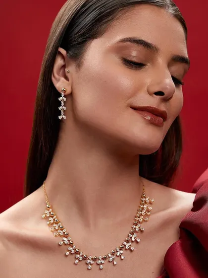 A serene and beautiful shot showcasing a matching necklace and earring set. The soft expression and gentle lighting convey a sense of timeless elegance.