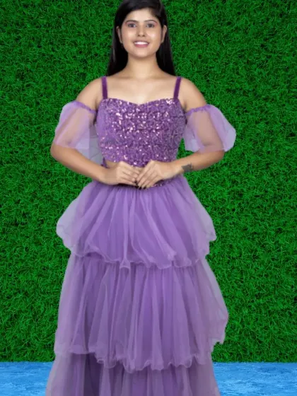 This lavender two-piece set includes a sequined off-shoulder top and a matching tiered skirt, offering a modern and glamorous take on the ruffle trend.