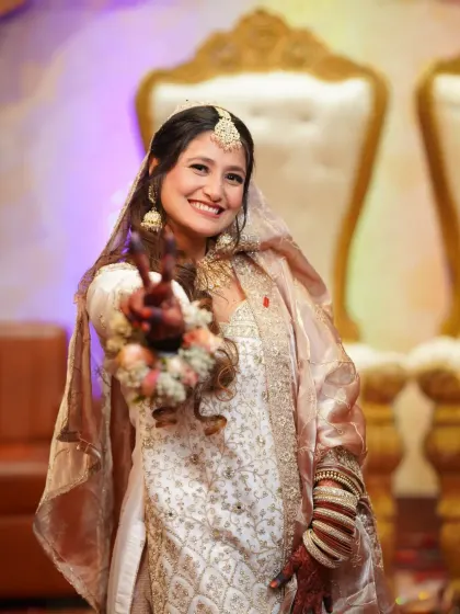 A joyful and candid portrait of the bride, her happiness radiating as she poses for the camera. We make sure to capture beautiful solo shots of the bride-to-be.
