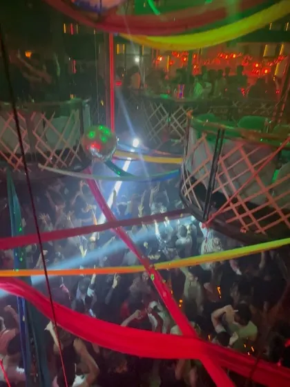 A wider shot of the party at The Fixx, with colorful streamers and a packed dance floor.