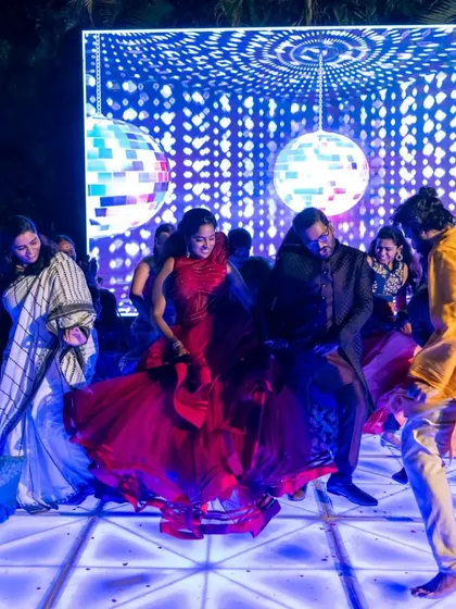 A beautiful shot of the bride and groom dancing with their guests under a disco ball. We help create the perfect party atmosphere with great music and lighting.