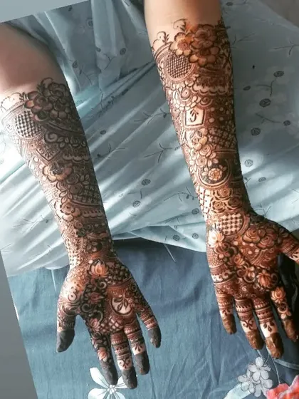 A full bridal design with a mix of lotus motifs, geometric patterns, and personalized initials. A truly unique design for a special bride.