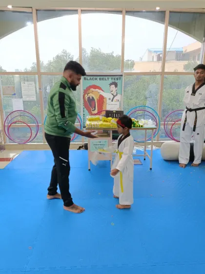 A young student receives his yellow belt.